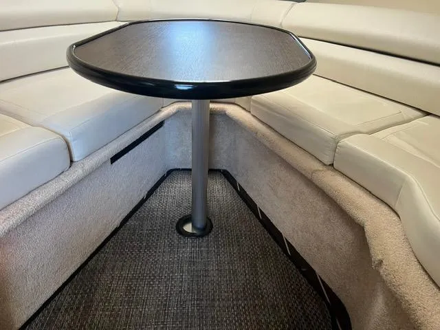 Slide: The Image of Interior seating area of 2017 Monterey 295 Sport Yacht with table and cushioned seats. - 15