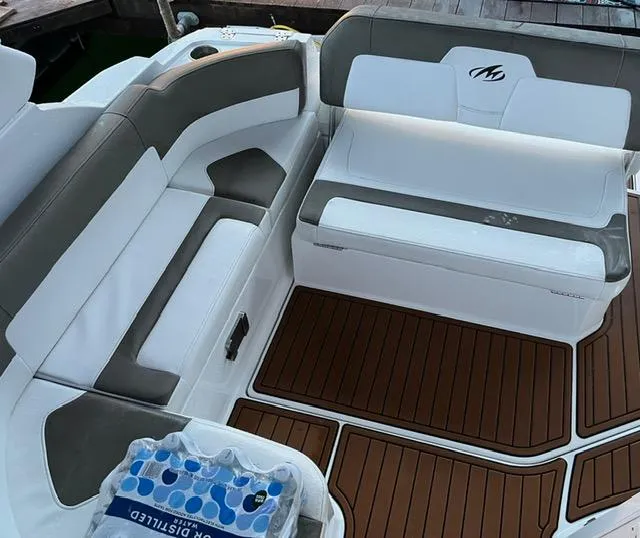 Slide: The Image of 2017 Monterey 295 Sport Yacht interior with white and gray seating, wooden flooring. - 18
