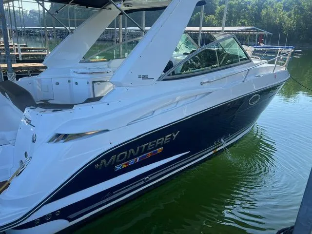 Slide: The Image of 2017 Monterey 295 Sport Yacht docked on calm water, showcasing sleek design and luxury features. - 2