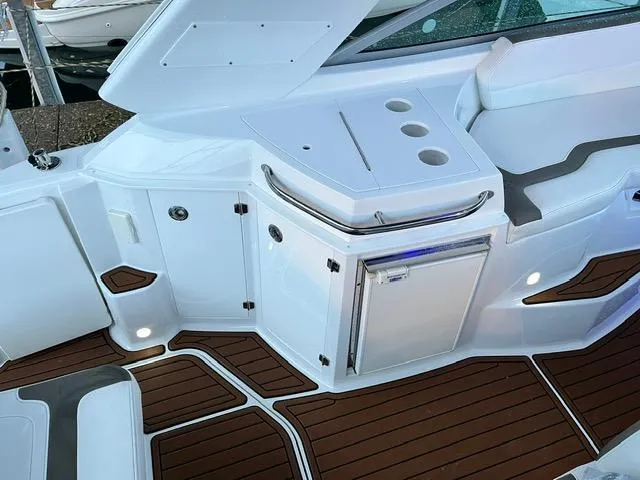 Slide: The Image of 2017 Monterey 295 Sport Yacht interior with sleek design and wood accents. - 23