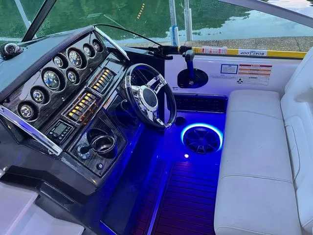 Slide: The Image of 2017 Monterey 295 Sport Yacht cockpit with illuminated controls and seating. - 5