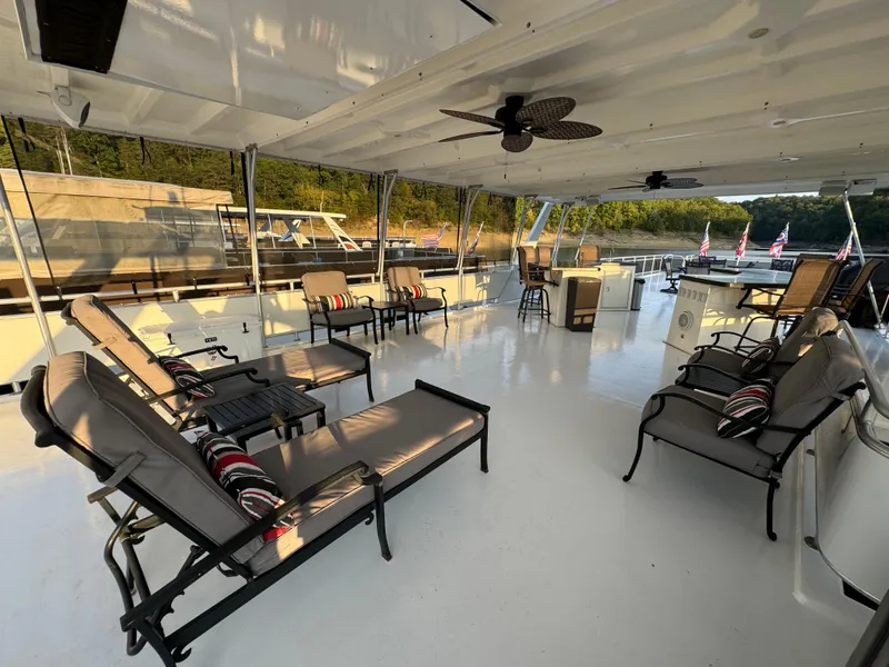 Slide: The Image of Spacious deck of 2004 Sumerset 20x100 houseboat with lounge chairs and scenic view. - 11
