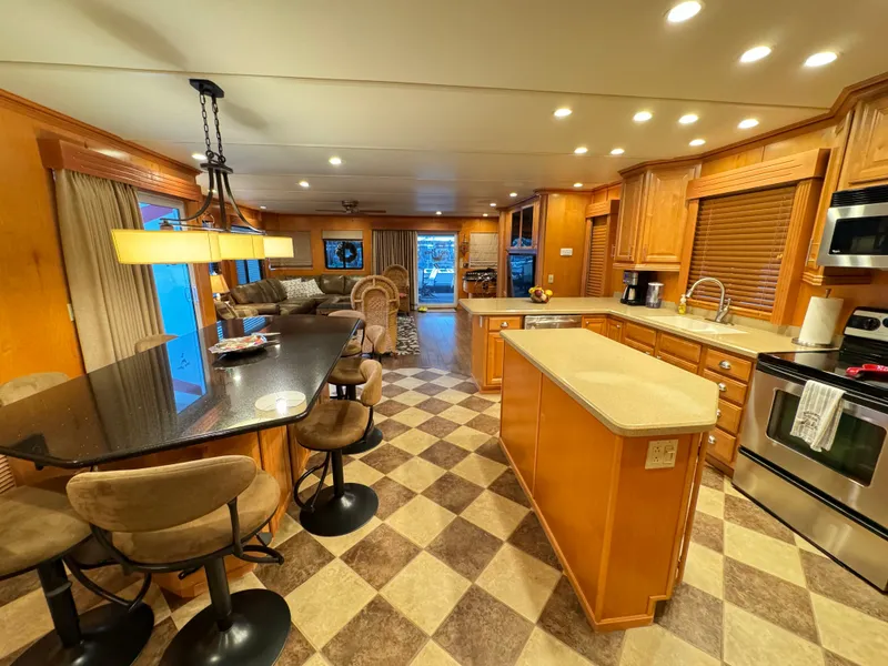 Slide: The Image of Luxurious 2004 Sumerset 20x100 houseboat kitchen with modern amenities and spacious dining area. - 16