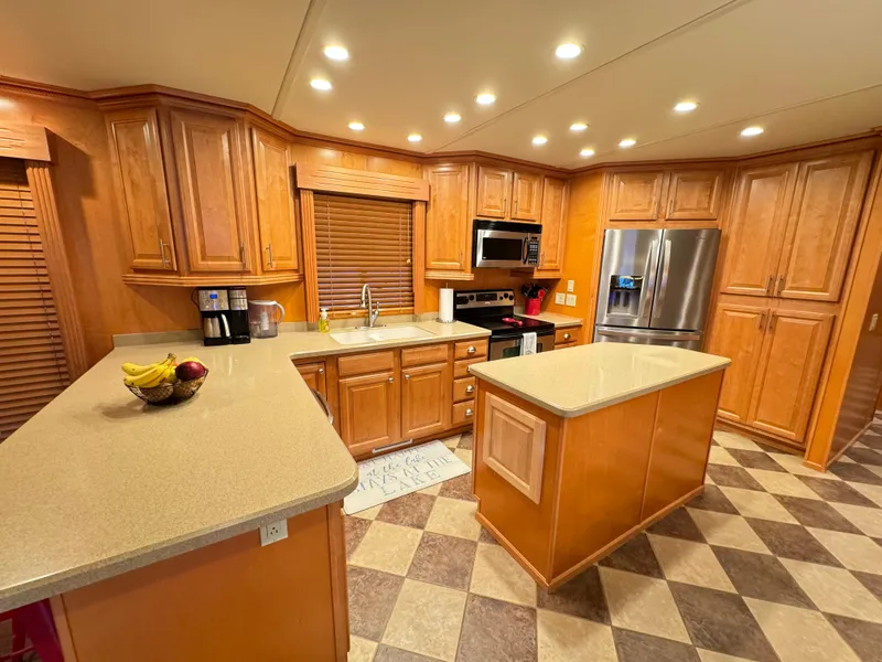 Slide: The Image of Spacious kitchen in 2004 Sumerset 20x100 houseboat with wooden cabinets and modern appliances. - 17