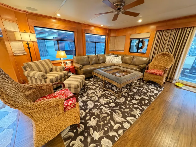 Slide: The Image of Cozy living room in 2004 Sumerset 20x100 houseboat with wicker chairs and patterned rug. - 20