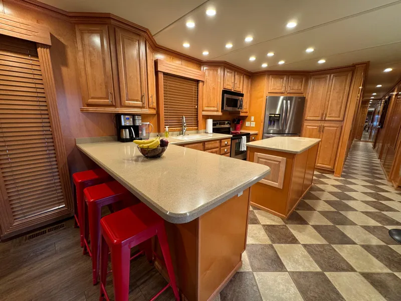 Slide: The Image of Spacious kitchen in 2004 Sumerset 20x100 houseboat with wooden cabinets and modern appliances. - 21