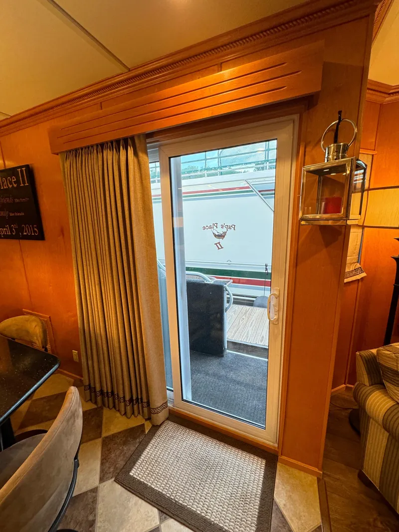 Slide: The Image of Interior view of 2004 Sumerset 20x100 houseboat with sliding glass door and curtains. - 23