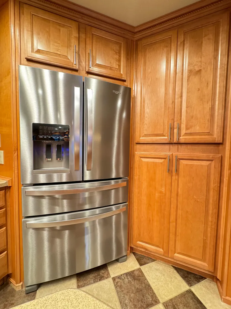 Slide: The Image of Stainless steel refrigerator in a wooden cabinet kitchen, Sumerset 20x100, 2004 model. - 25