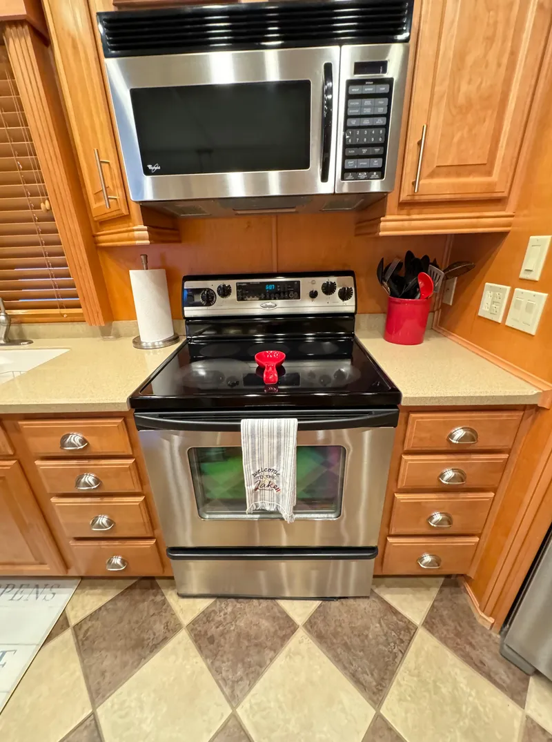 Slide: The Image of Modern kitchen with stainless steel appliances in a 2004 Sumerset 20x100 houseboat. - 26