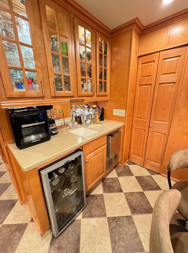 Slide: The Image of 2004 Sumerset 20x100 houseboat kitchen with wooden cabinets and checkered floor. - 27