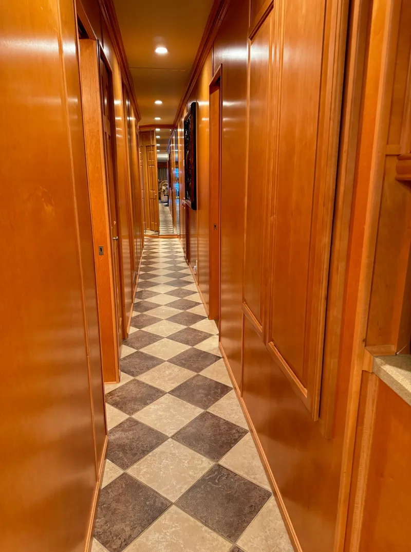 Slide: The Image of Narrow hallway with wooden paneling and checkered flooring in a 2004 Sumerset 20x100 houseboat. - 29