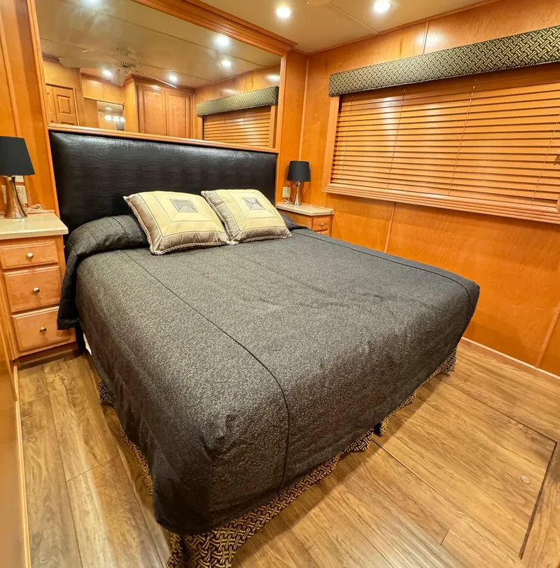 Slide: The Image of Luxurious bedroom in 2004 Sumerset 20x100 houseboat with wood accents and cozy bedding. - 30