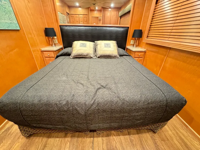 Slide: The Image of Luxurious bedroom in 2004 Sumerset 20x100 houseboat with elegant wood paneling and cozy bedding. - 31