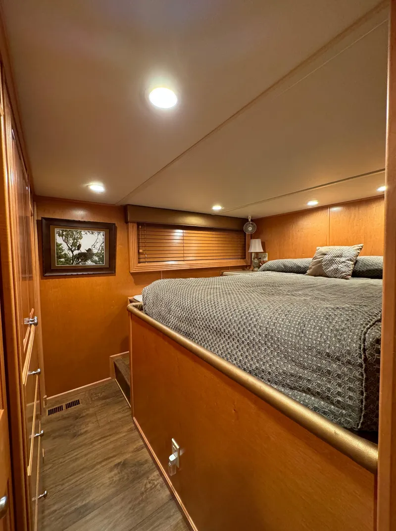 Slide: The Image of Cozy bedroom in 2004 Sumerset 20x100 houseboat with wood paneling and ambient lighting. - 35