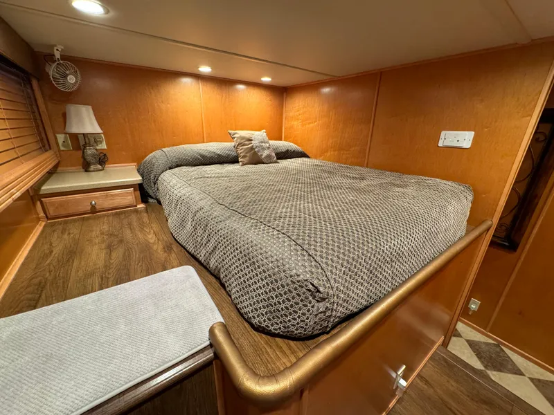 Slide: The Image of Cozy bedroom in 2004 Sumerset 20x100 houseboat with wood paneling and ambient lighting. - 36
