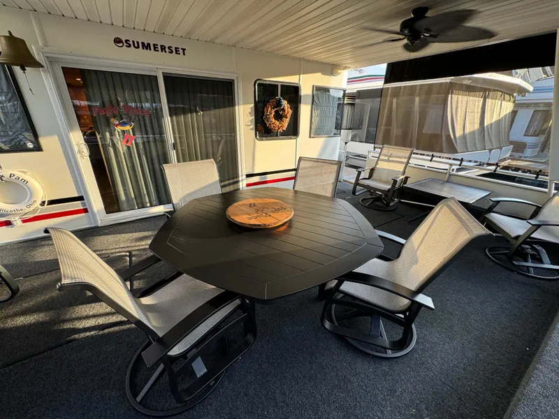 Slide: The Image of Outdoor seating area on 2004 Sumerset 20x100 houseboat with table and chairs. - 4