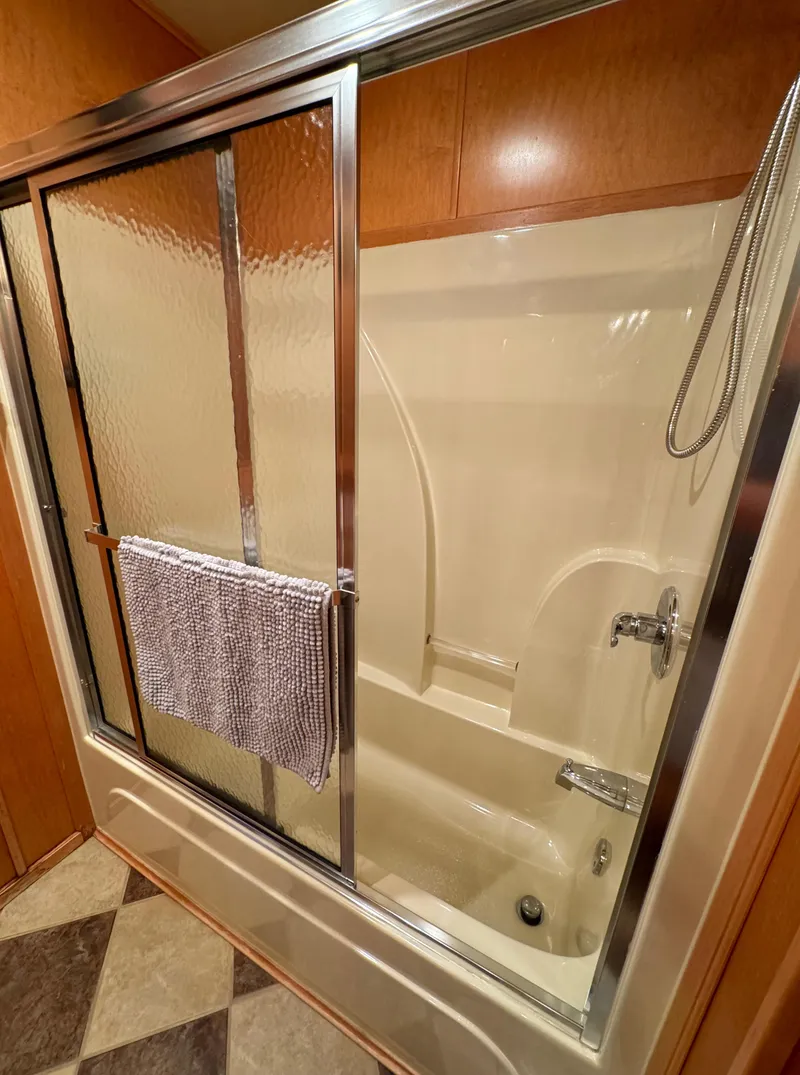 Slide: The Image of 2004 Sumerset 20x100 bathroom with glass shower doors and towel. - 40