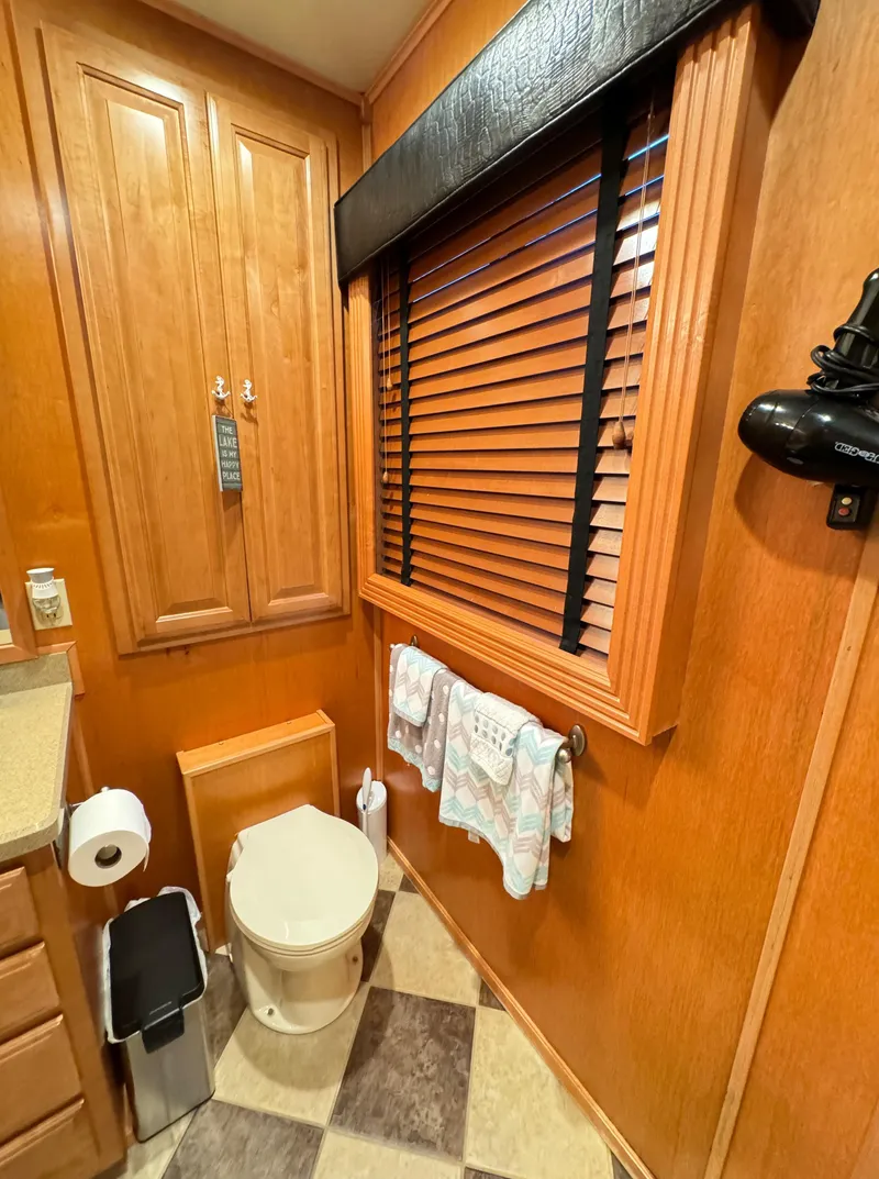 Slide: The Image of 2004 Sumerset 20x100 houseboat bathroom with wooden cabinets and blinds. - 41