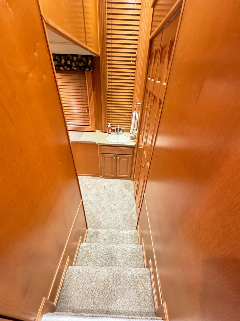 Slide: The Image of Interior of 2004 Sumerset 20x100 houseboat with wooden stairs and cabinetry. - 43