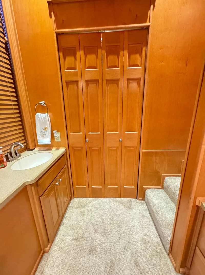 Slide: The Image of 2004 Sumerset 20x100 interior with wooden cabinetry and carpeted flooring. - 44