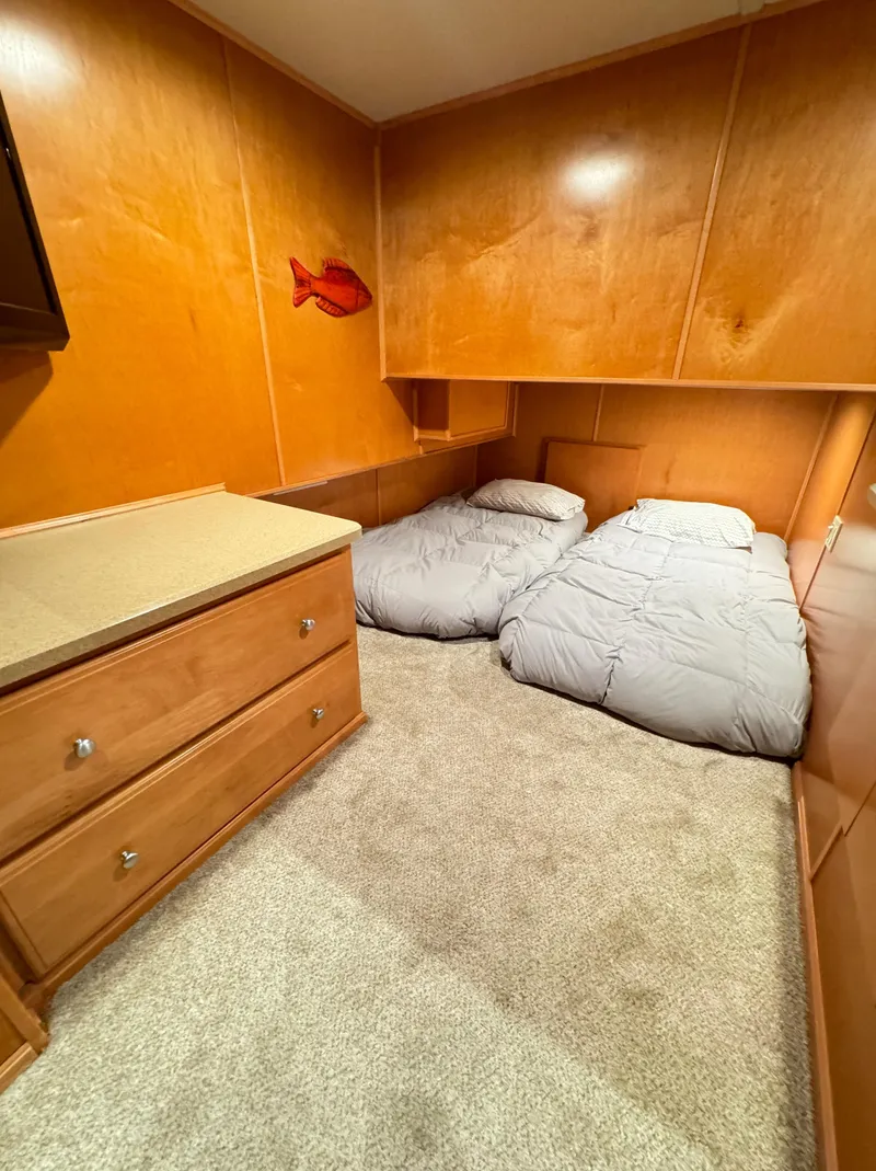 Slide: The Image of Cozy bedroom in 2004 Sumerset 20x100 houseboat with twin beds and wooden cabinetry. - 46