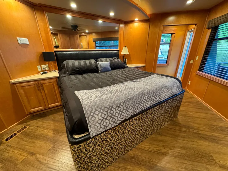 Slide: The Image of Luxurious bedroom in 2004 Sumerset 20x100 houseboat with elegant wood paneling and cozy bedding. - 47