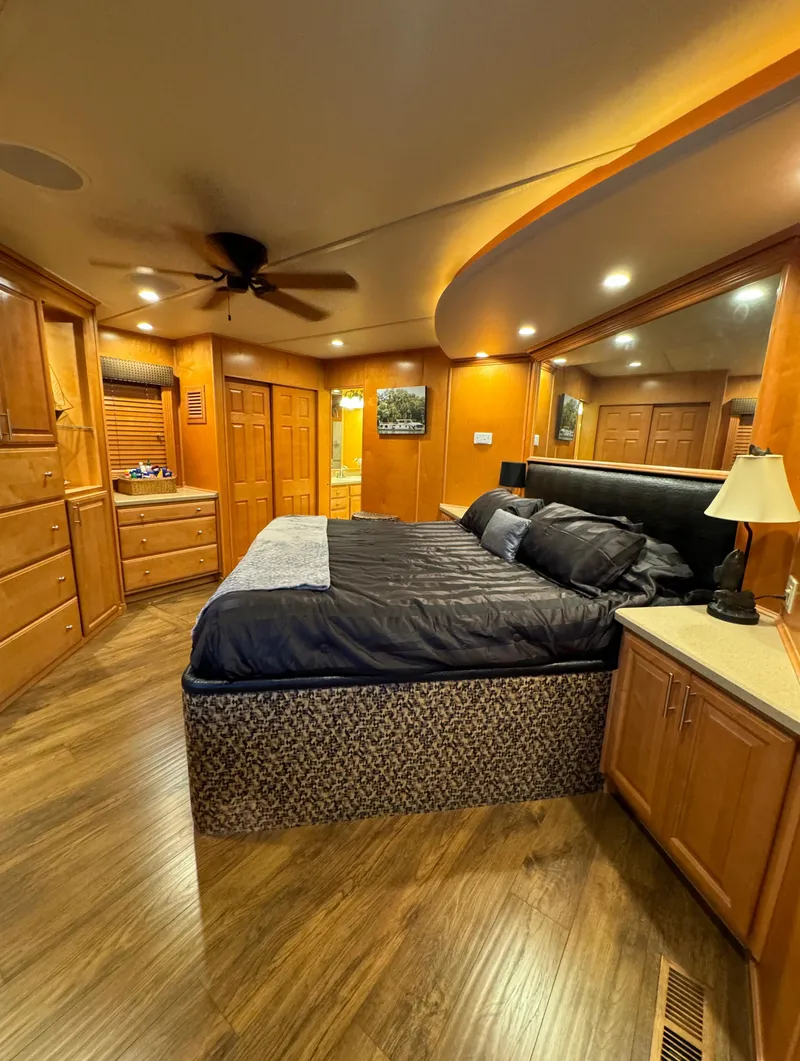 Slide: The Image of Luxurious bedroom in 2004 Sumerset 20x100 houseboat with wood accents and modern lighting. - 48