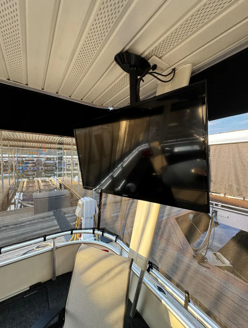 Slide: The Image of 2004 Sumerset 20x100 houseboat interior with mounted flat-screen TV. - 5