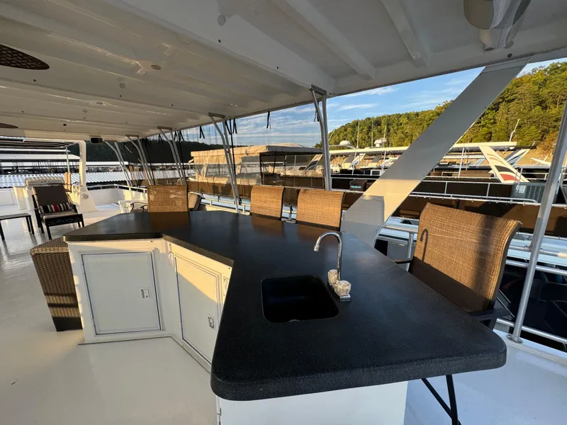 Slide: The Image of Spacious 2004 Sumerset 20x100 houseboat deck with seating and sink. - 9