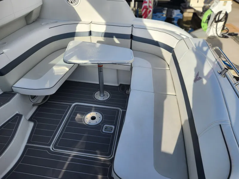 Slide: The Image of 2002 Formula 37 PC boat interior with white seating and a small table. - 11