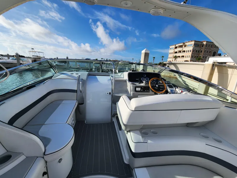 Slide: The Image of 2002 Formula 37 PC yacht interior with sleek seating and modern dashboard, docked at marina. - 15