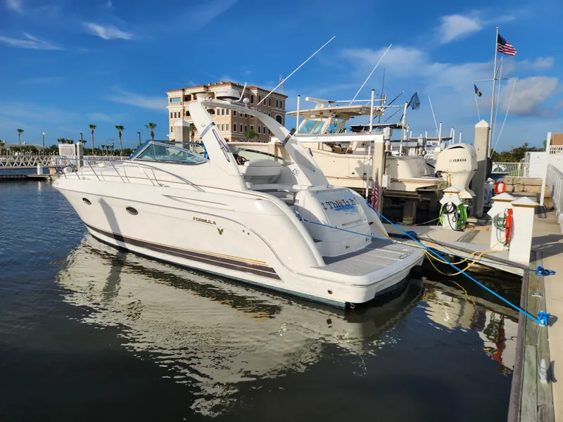 Slide: The Image of 2002 Formula 37 PC yacht docked at marina under clear blue sky. - 2