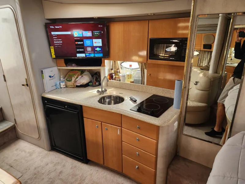 Slide: The Image of 2002 Formula 37 PC yacht interior with kitchenette, TV, and modern amenities. - 21