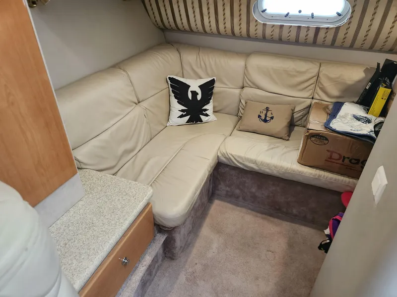 Slide: The Image of 2002 Formula 37 PC cabin with beige leather seating and nautical-themed pillows. - 23