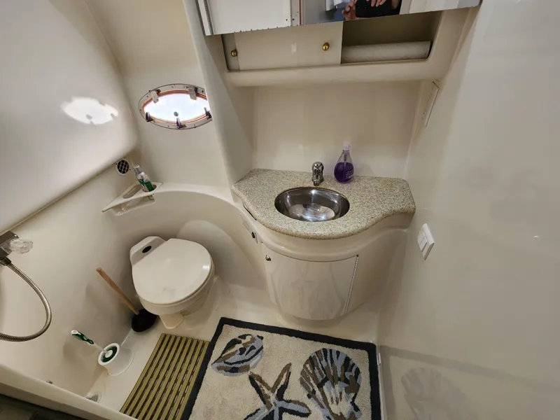 Slide: The Image of 2002 Formula 37 PC yacht bathroom with sink, toilet, and nautical-themed decor. - 25