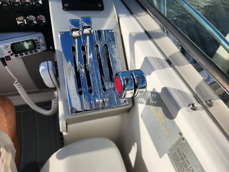 Slide: The Image of Control panel of a 2002 Formula 37 PC boat with chrome levers and a red button. - 32