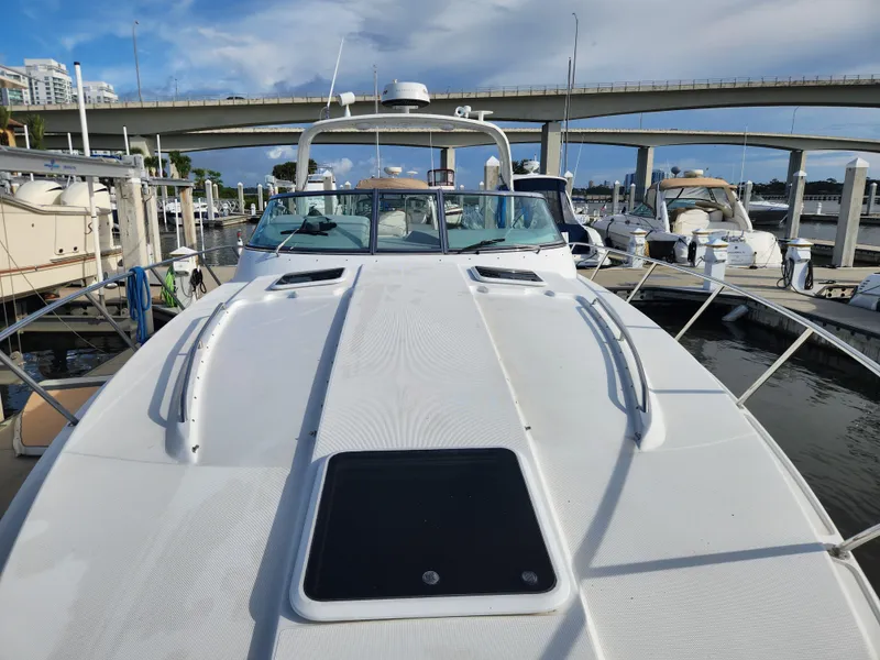 Slide: The Image of 2002 Formula 37 PC yacht docked at marina, bridge in background, clear sky. - 6