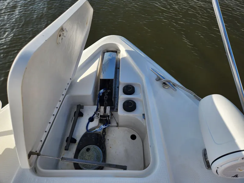 Slide: The Image of Anchor compartment of 2002 Formula 37 PC boat, open hatch, docked on water. - 8