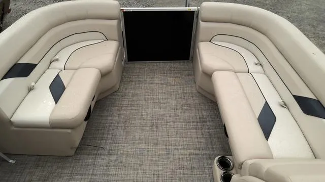 Slide: The Image of 2024 SunCatcher Select 20C pontoon boat interior with beige seating and gray flooring. - 15