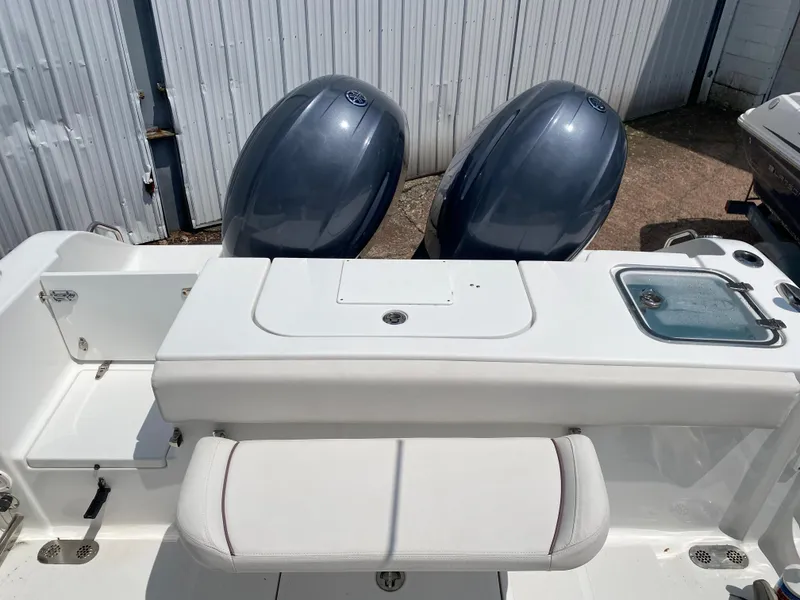 Slide: The Image of 2020 Sea Hunt Gamefish 25 boat with dual outboard motors and seating area. - 10