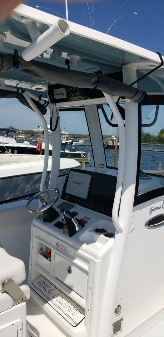 Slide: The Image of 2020 Sea Hunt Gamefish 25 boat console with steering wheel and controls. - 13