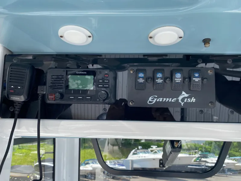 Slide: The Image of 2020 Sea Hunt Gamefish 25 control panel with Garmin radio and light switches. - 15
