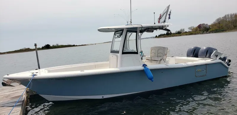 Slide: The Image of 2020 Sea Hunt Gamefish 25 boat docked on calm water. - 4