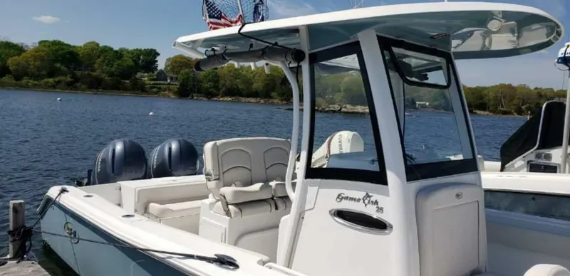 Slide: The Image of 2020 Sea Hunt Gamefish 25 boat docked on a serene lake. - 7