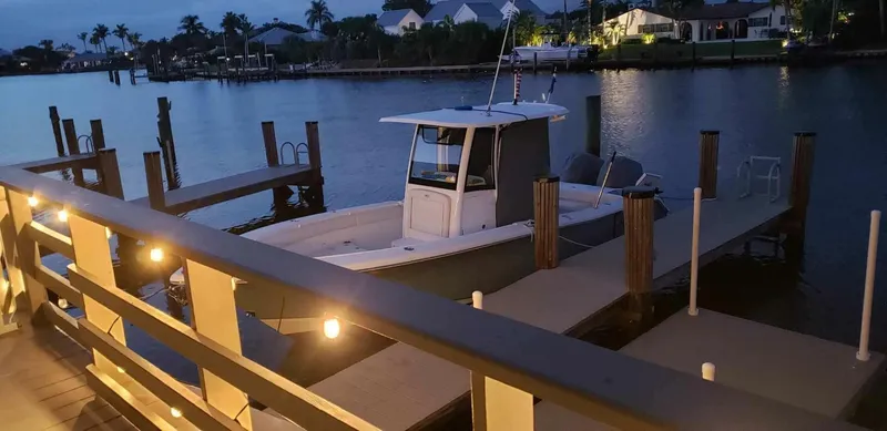 Slide: The Image of 2020 Sea Hunt Gamefish 25 docked at a marina during twilight. - 8