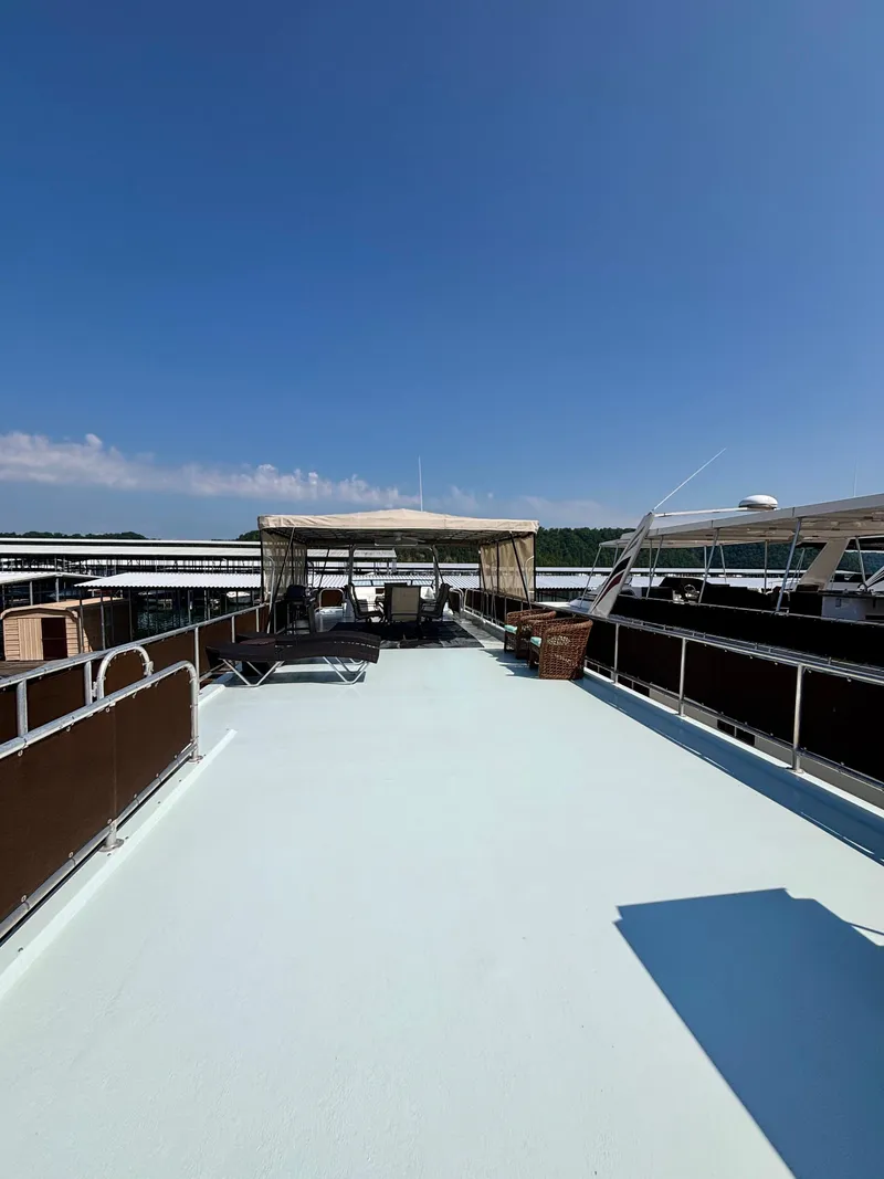Slide: The Image of Rooftop deck of 2012 Horizon 16x66 houseboat under clear blue sky. - 13