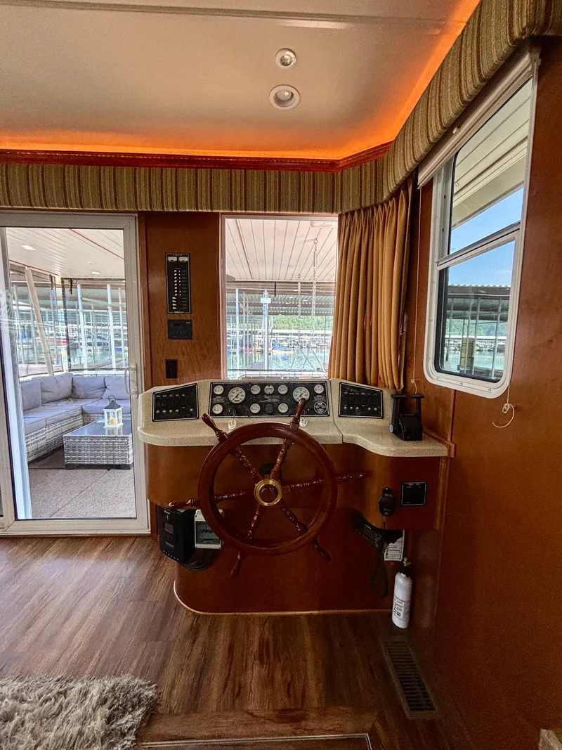 Slide: The Image of Pilothouse of 2012 Horizon 16x66 boat with wooden steering wheel and control panel. - 16