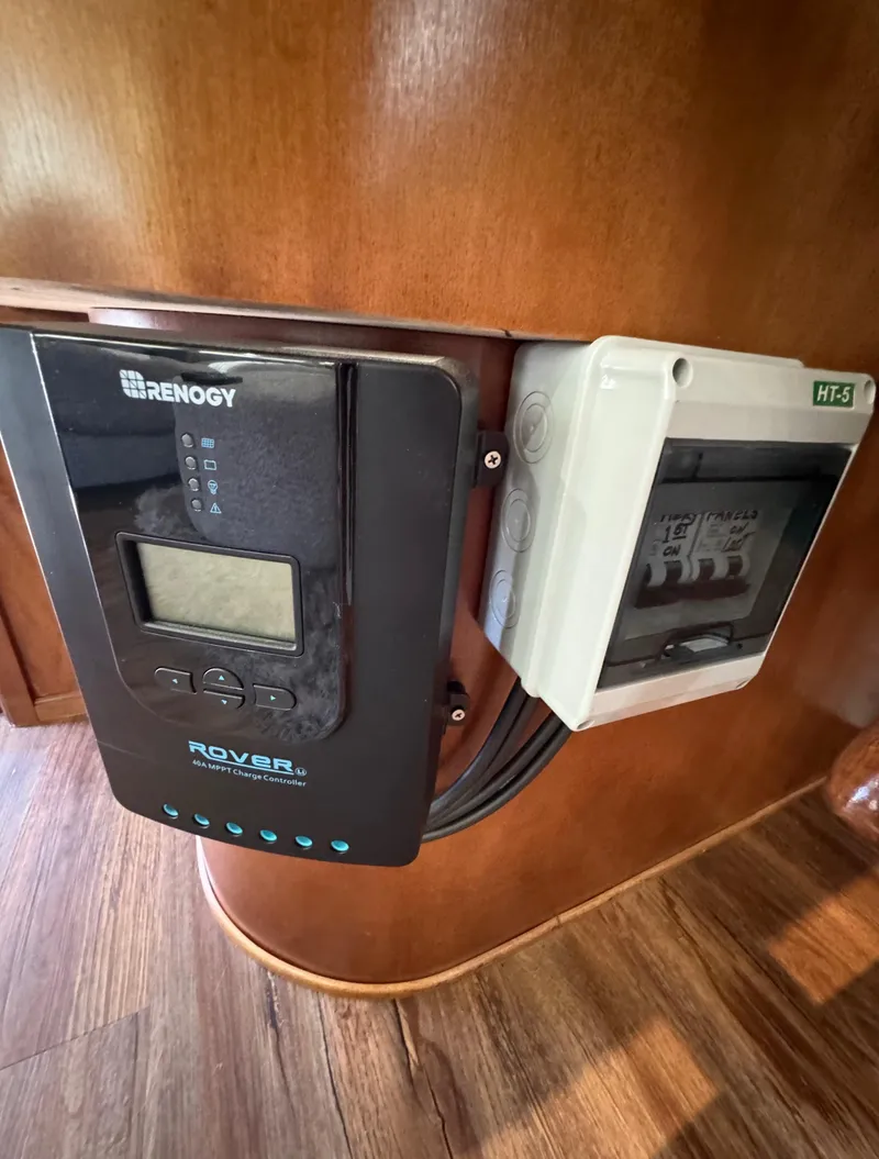 Slide: The Image of Renogy Rover solar charge controller on Horizon 16x66, 2012 model, mounted on wooden panel. - 17