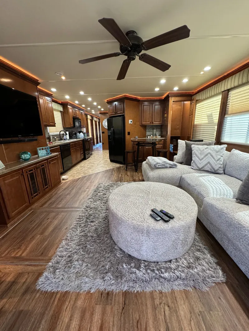 Slide: The Image of Spacious 2012 Horizon 16x66 houseboat interior with modern kitchen, cozy living area, and ceiling fan. - 19