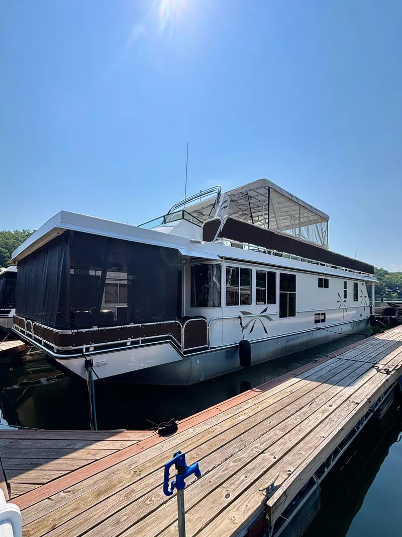 Slide: The Image of 2012 Horizon 16x66 houseboat docked under clear blue sky. - 2